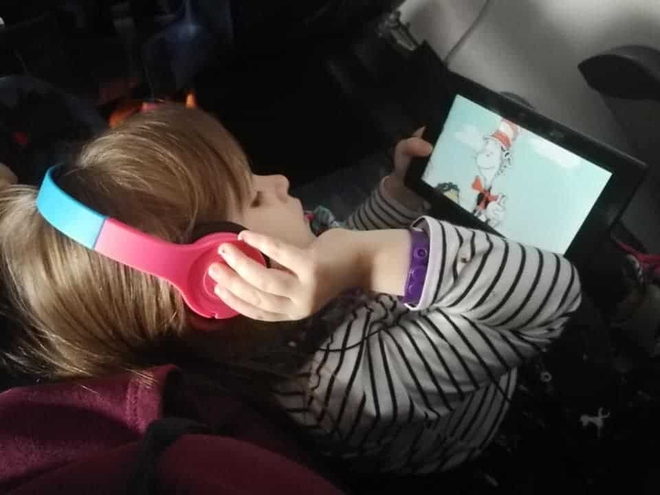 My daughter using her headphones on a trip